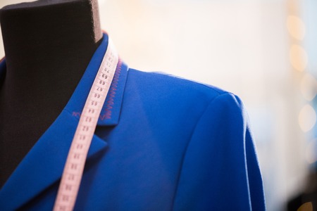 Close up of classic jacket in electric blue color shown on mannequin in atelier studio, copy spaceの写真素材