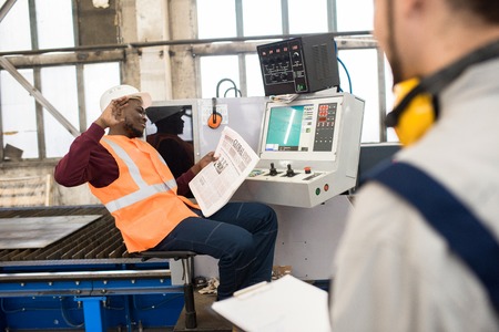 Careless manufacturing employees chatting at workplace