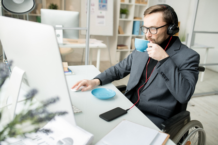 Disabled businessman working at officeの写真素材