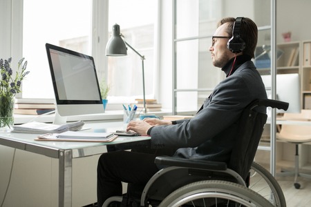 Busy businessman in wheelchairの写真素材