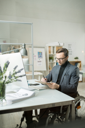 Businessman doing paperwork at officeの写真素材