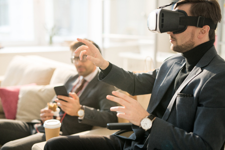Using virtual reality device during business breakの写真素材