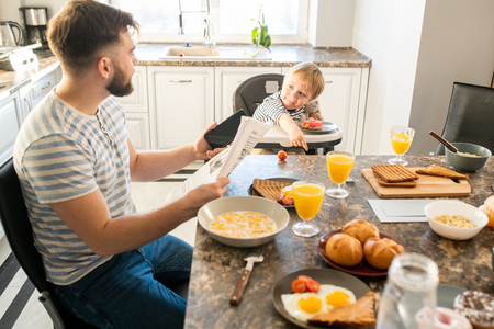 Young Father at Breakfastの写真素材