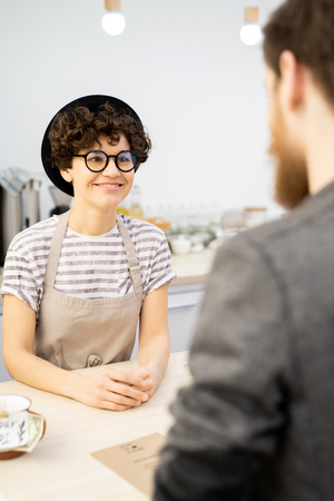 Smiling barista listening to customerの写真素材