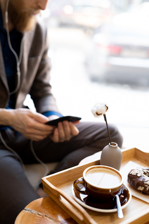 Morning cappuccino with chocolate doughnutの写真素材