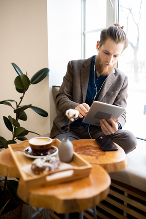 Busy freelancer working in cozy coffee shopの写真素材
