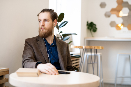 Sad pensive man in cafeの写真素材