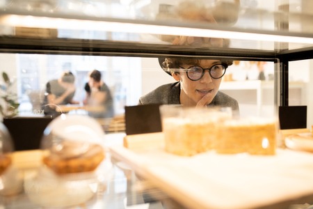 Attractive lady choosing dessertの写真素材