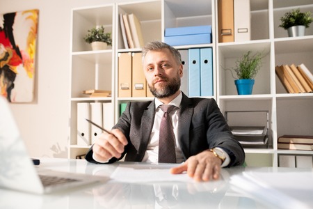 Confident handsome manager in modern officeの写真素材