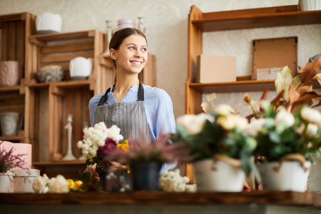 Smiling Woman Working in Flower Shopの写真素材
