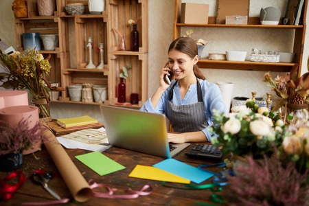 Young Businesswoman Managing Shopの写真素材