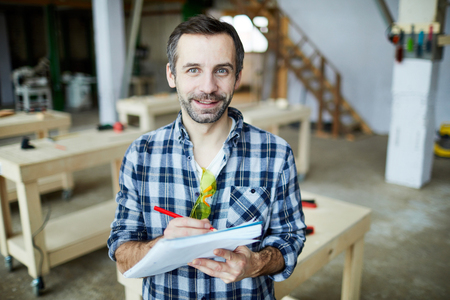 Handsome carpenter developing design of new detailの写真素材