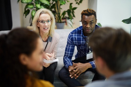 Multi-ethnic colleagues participating in discussionの写真素材
