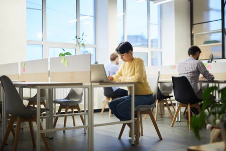 Student girl working on project in coworking spaceの写真素材