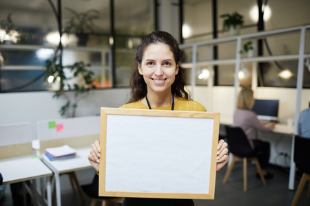 Cheerful lady holding blank bannerの写真素材