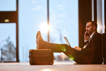 Phoning in airportの写真素材
