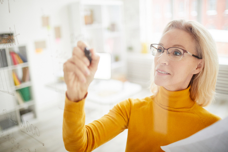 Businesswoman Writing on Glassの写真素材