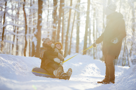 Happy Family Enjoying Sleigh Rideの写真素材