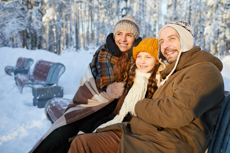 Joyful Family in Winter Parkの写真素材