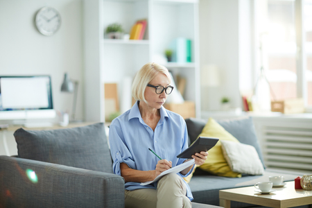 Mature Woman Calculating Budgetの写真素材
