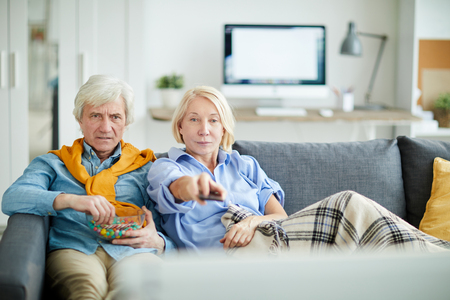 Senior Couple watching Televisionの写真素材