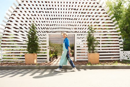 Gardener Walking past Orchardの写真素材
