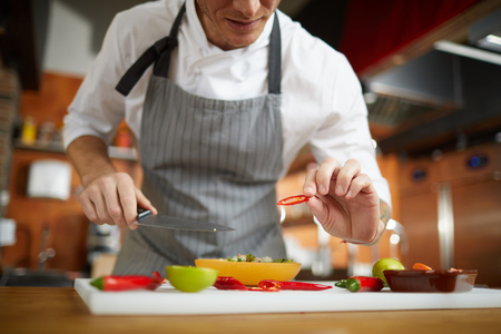 Unrecognizable Chef Cutting Vegetablesの写真素材