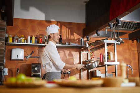 Professional Chef Cooking in Kitchenの写真素材