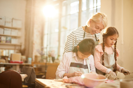 Two Little Girls in Pottery Classの写真素材