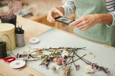 Unrecognizable Florist Taking Photoの写真素材