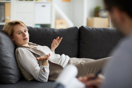 Woman talking on couchの写真素材