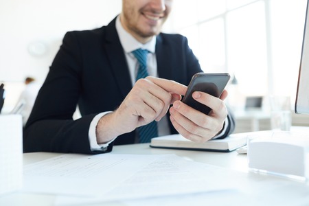 Messaging by deskの写真素材