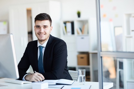 Businessman by deskの写真素材
