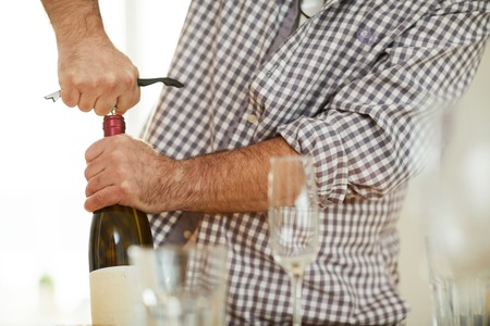Drawing cork from wine bottleの写真素材