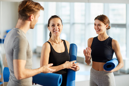 Yoga students discussing new exercisesの写真素材