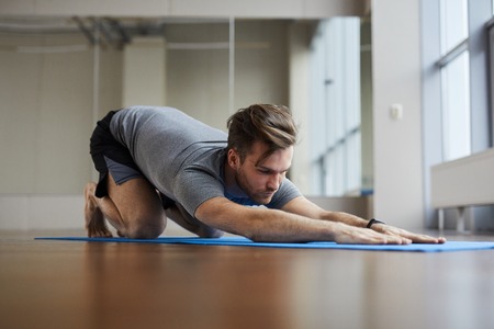 Man doing restorative yoga poseの写真素材