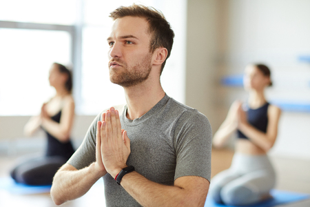 Peaceful man meditating at yogaの写真素材