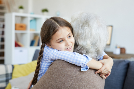 Little Girl Embracing Grandmotherの写真素材