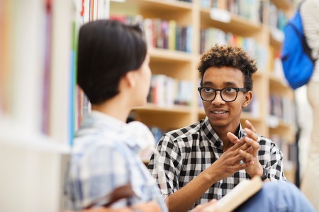 Smart students planning research project in libraryの写真素材