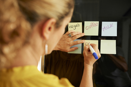 Woman writing shopping listの写真素材