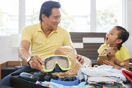 Father and daughter getting ready for vacationの写真素材