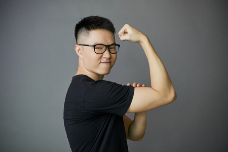 Young man showing bicepsの写真素材