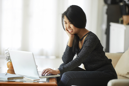 Young woman working on laptopの写真素材