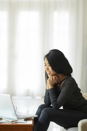 Woman watching movie on laptopの写真素材
