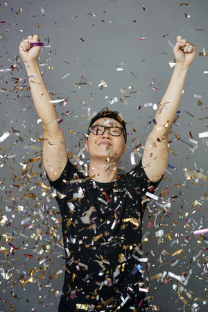Man standing in falling confettiの写真素材