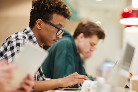 Black student concentrated on coding