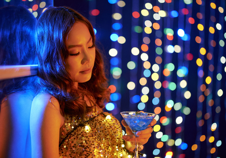 Young woman drinking a cocktailの写真素材