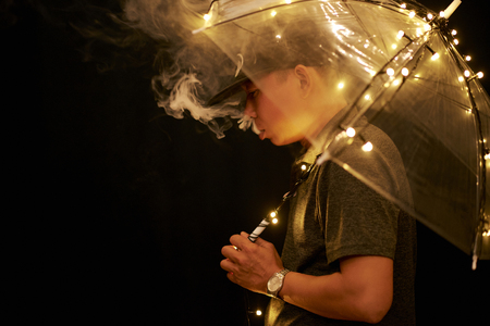 Young man under the umbrellaの写真素材
