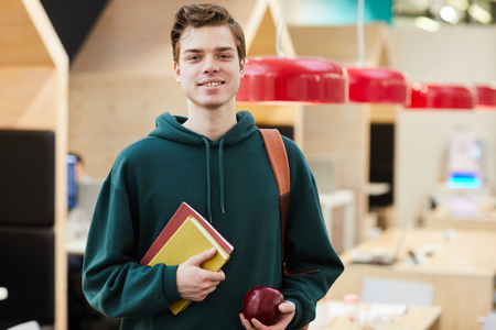 Positive young guy with workbooksの写真素材