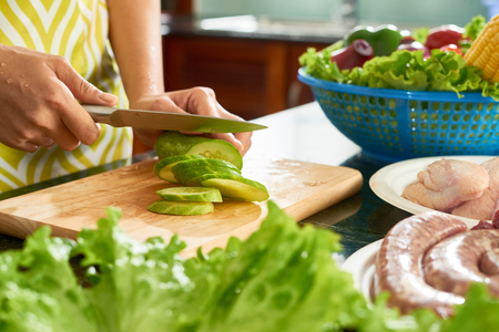 Cutting cucumber for saladの写真素材